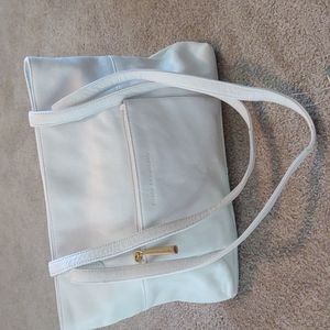 Stone Mountain all genuine leather white purse with pockets and zippers galore.